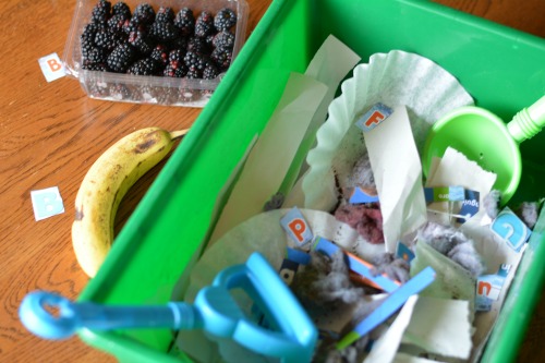matching letters and sounds with a compost alphabet bin