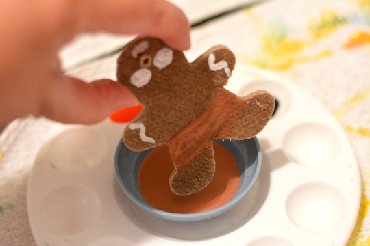 dipping boots in paint for ornaments made of gingerbread salt dough