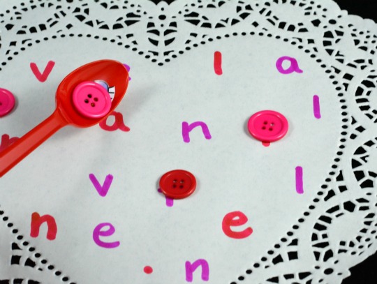 placing buttons on the heart for Valentine's Day